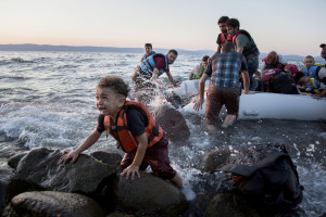 A terrified child clings to a rock on the shore as a group of Syrian refugees arrive on the island after travelling by inflatable raft from Turkey. The Eastern Mediterranean route from Turkey to Greece has overtaken the central Mediterranean route, from North Africa to Italy, as the primary one for arrivals by sea. From January to June this year, 68,000 people arrived in Greece, compared with 67,500 in Italy, accounting for nearly all the arrivals in the period.